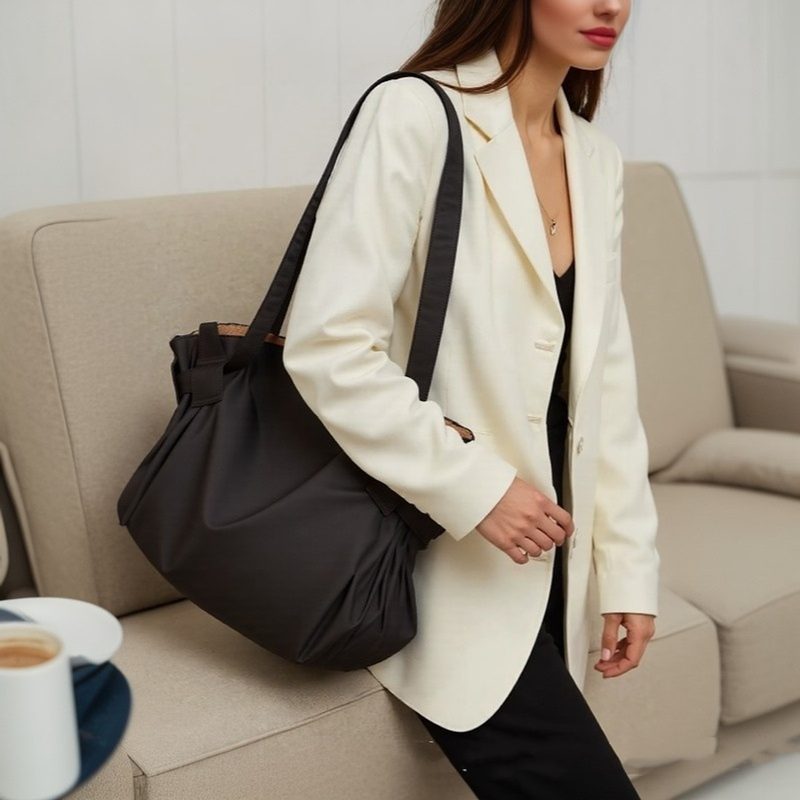 Black slouchy everyday tote bag on a shoulder