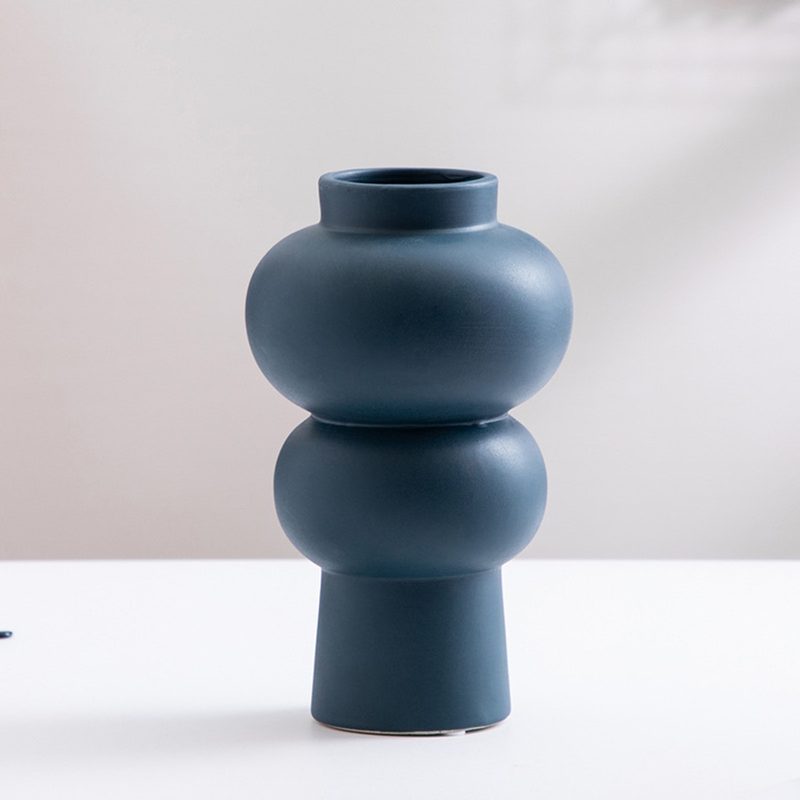 deep navy sculptural ceramic vase with stacked curves