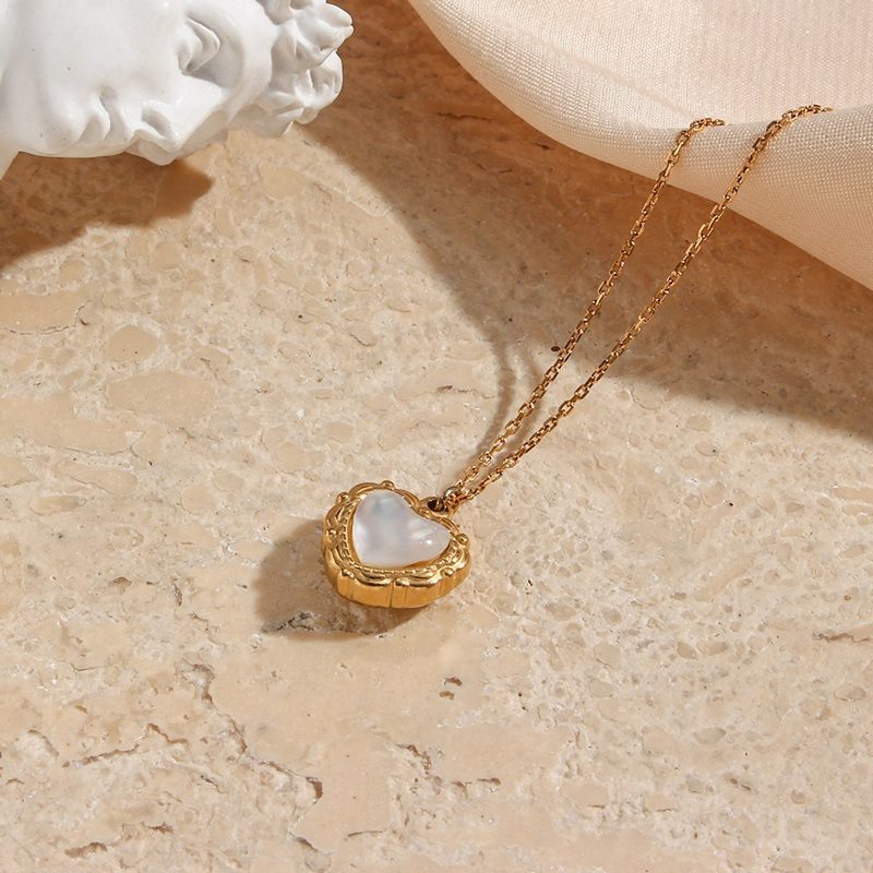 Gold shell heart pendant on a fine chain
