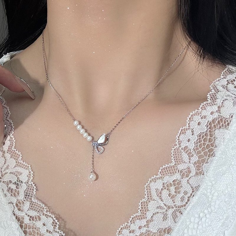silver-tone bow necklace with a pearl drop