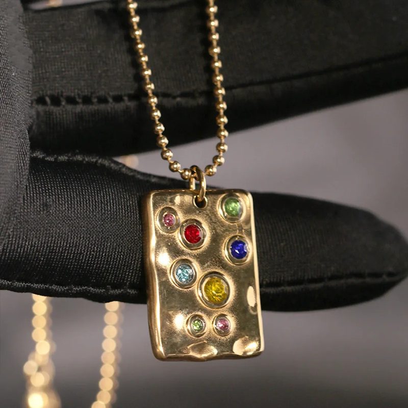Gold tone geometric pendant necklace on a fine chain