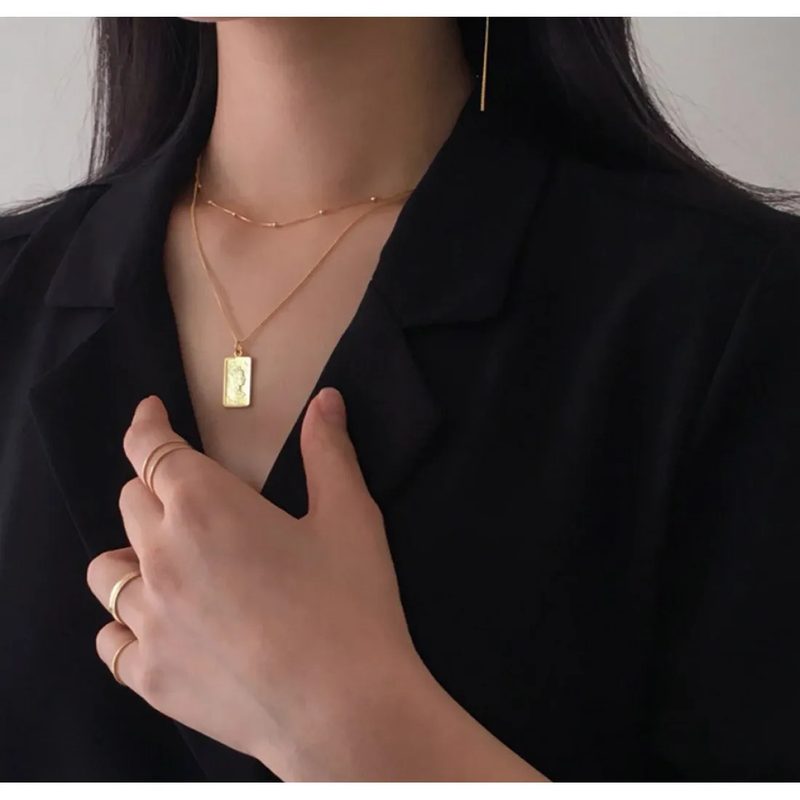 silver-tone square pendant necklace with a gold finish