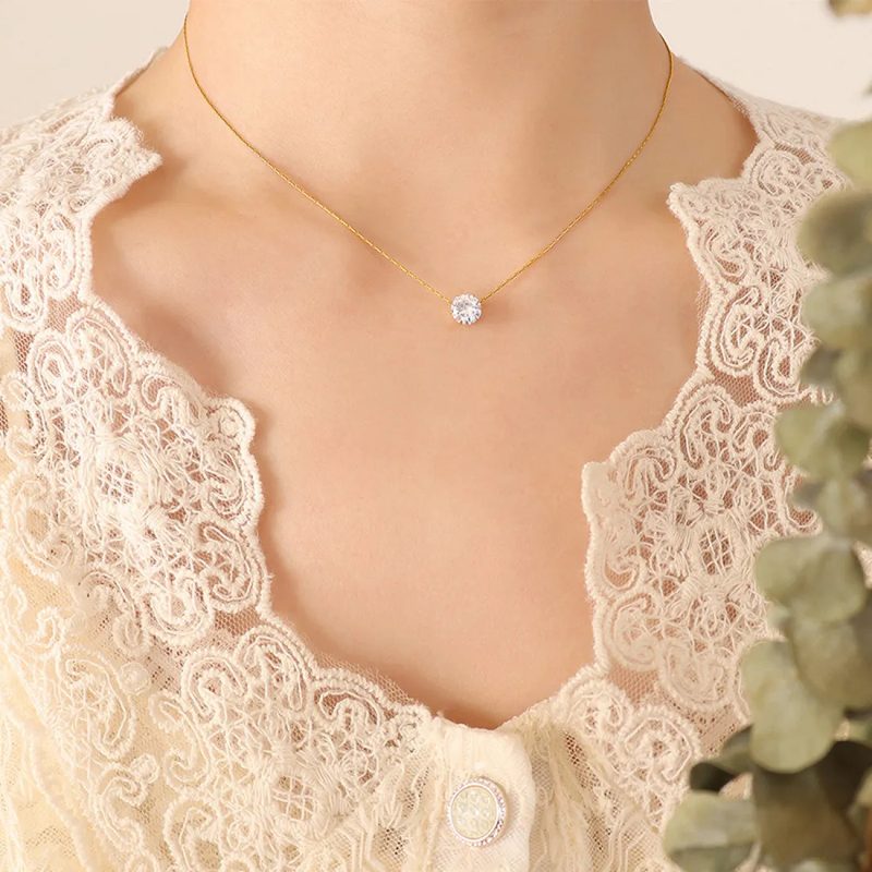 Silver tone solitaire pendant necklace with a single clear stone