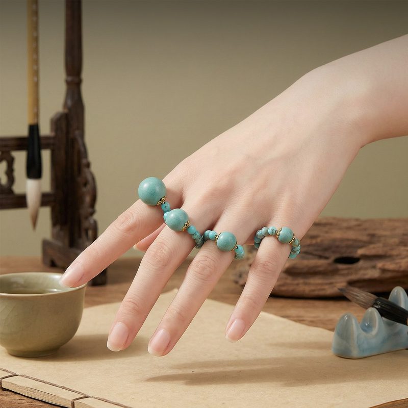 Set of dainty turquoise stacking rings on a hand