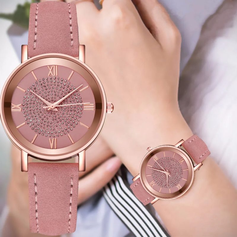 Rose gold watch with a sunburst dial and roman numerals on a plain background
